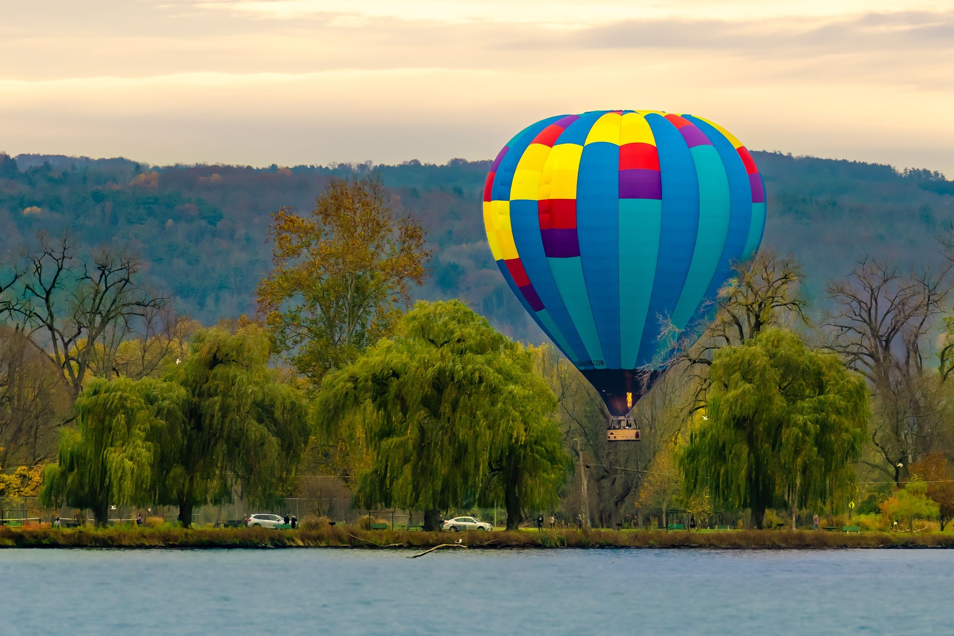 Beautiful Hot Air Balloon preparing to land in Stewart Park at Cayuga Lake on a Saturday evening.